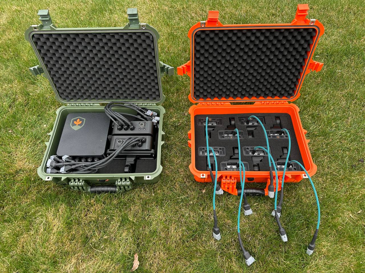 FarmDefender kit packed in weatherproof cases — central ECU with cabling in one, camera units foam-fitted in the other